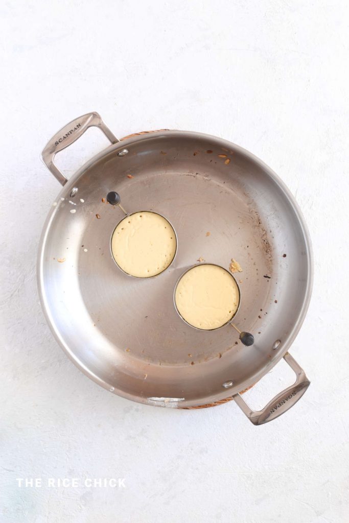 Mochi pancakes in a frying pan.