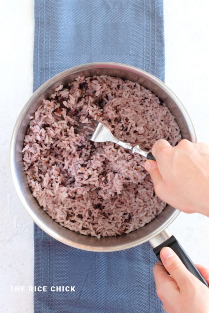 Fluffing Korean purple rice.