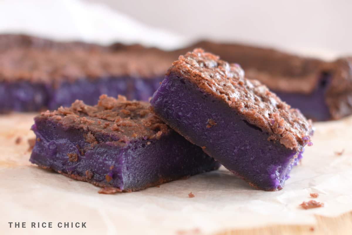 Cut slices of ube butter mochi on parchment paper.