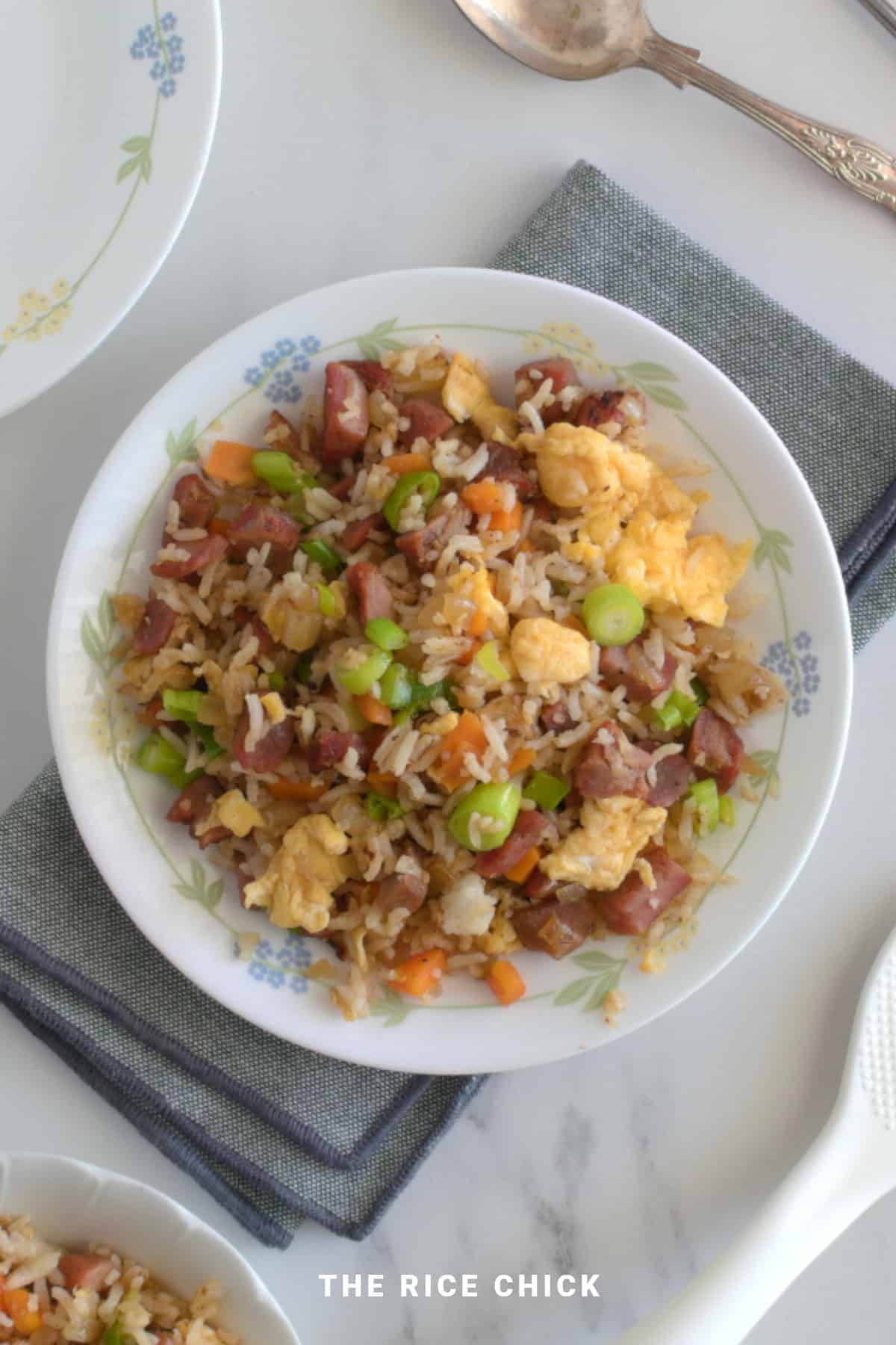 Fried rice with Chinese BBQ pork on a white plate.
