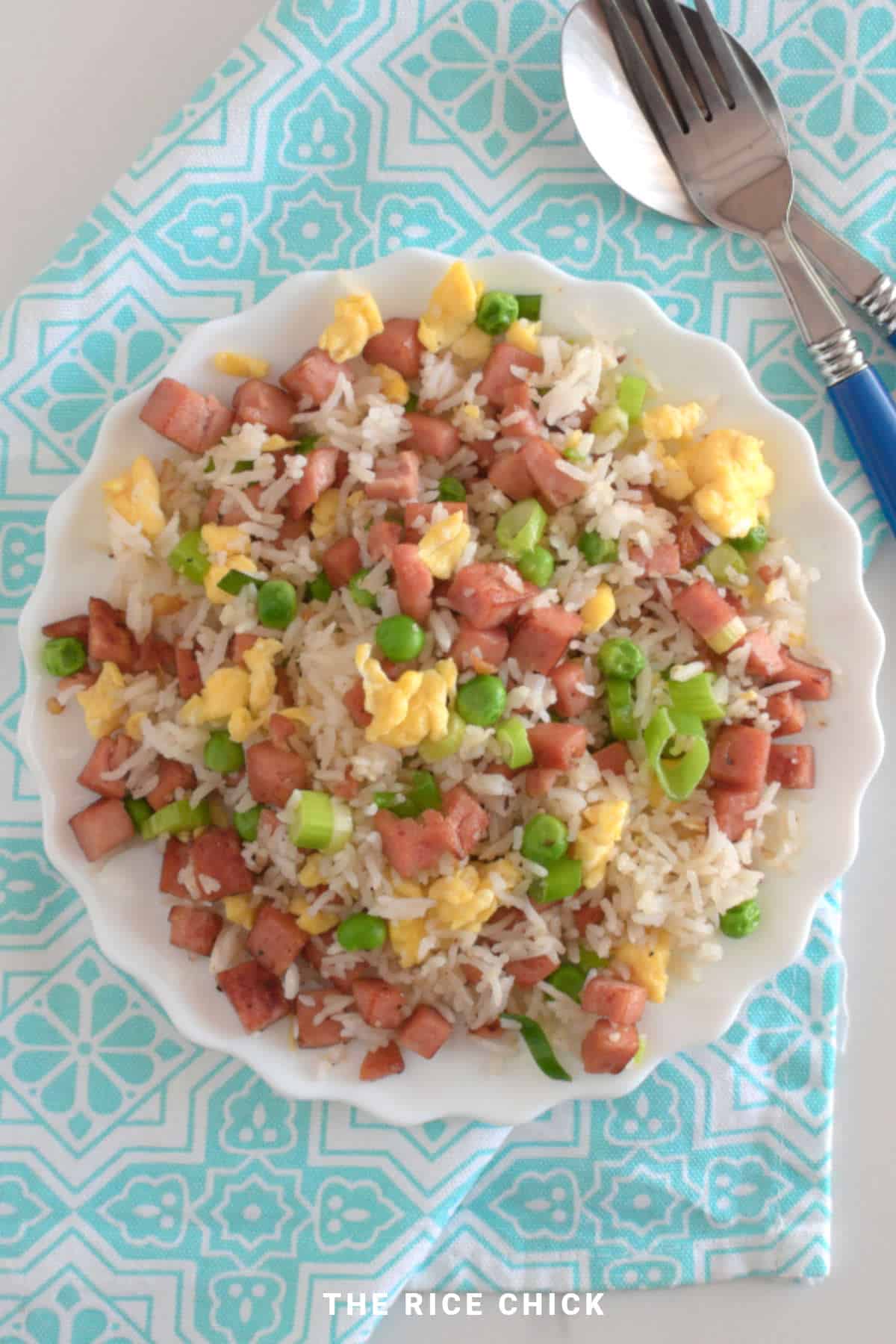 Fried rice with spam on a round white plate.
