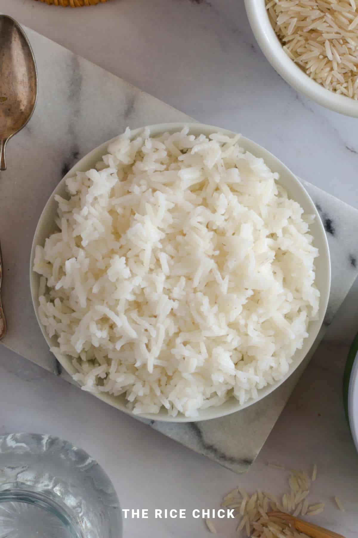 Cooked basmati rice in a bowl on a marble board.