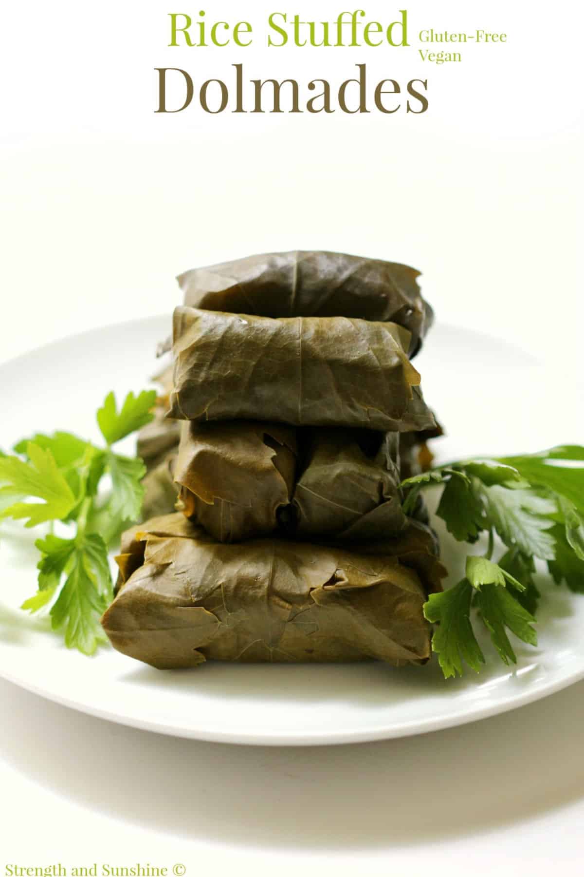 A stack of rice stuffed dolmades on a plate.