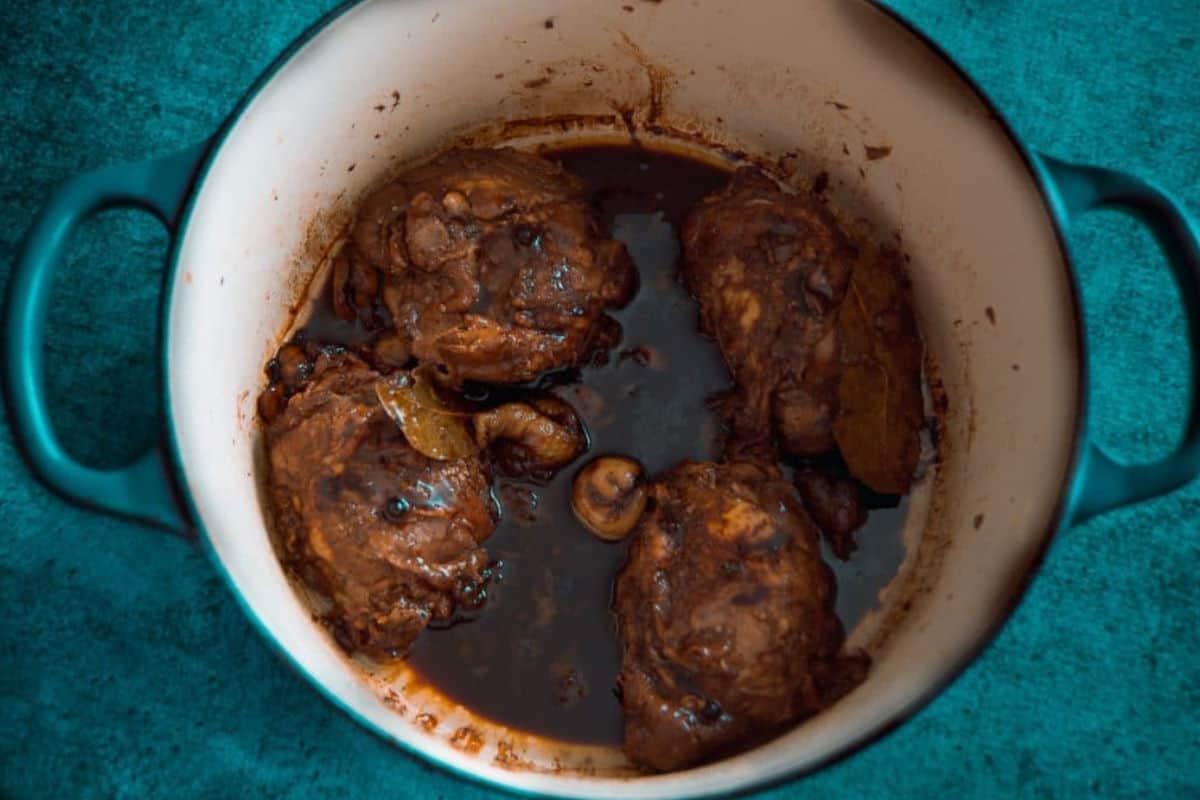 Close up image of chicken adobo in a pot.