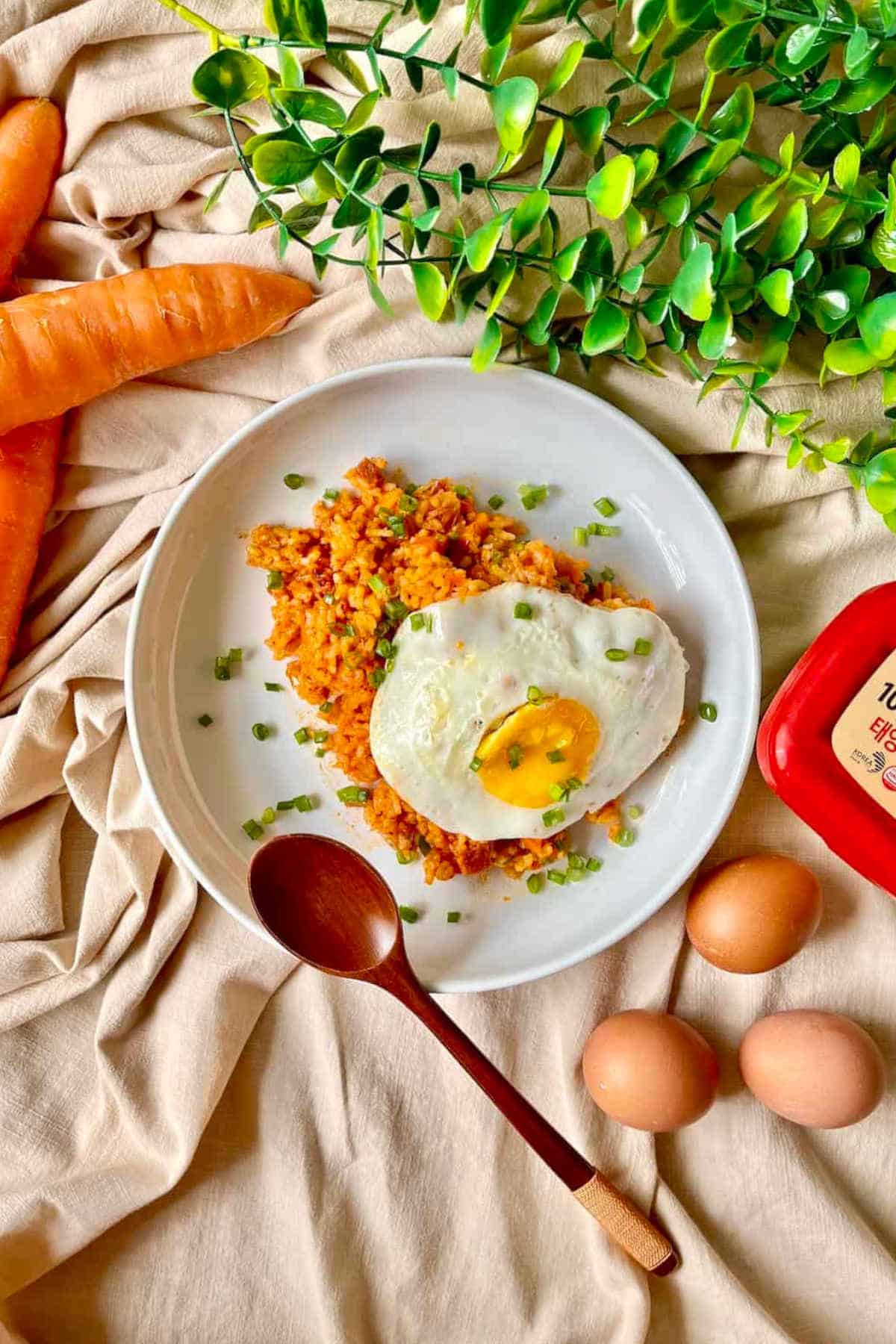 Kimchi fried rice on a plate topped with a fried egg.