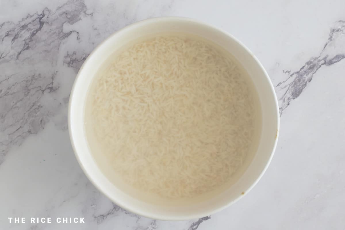 Water and uncooked rice in a bowl.