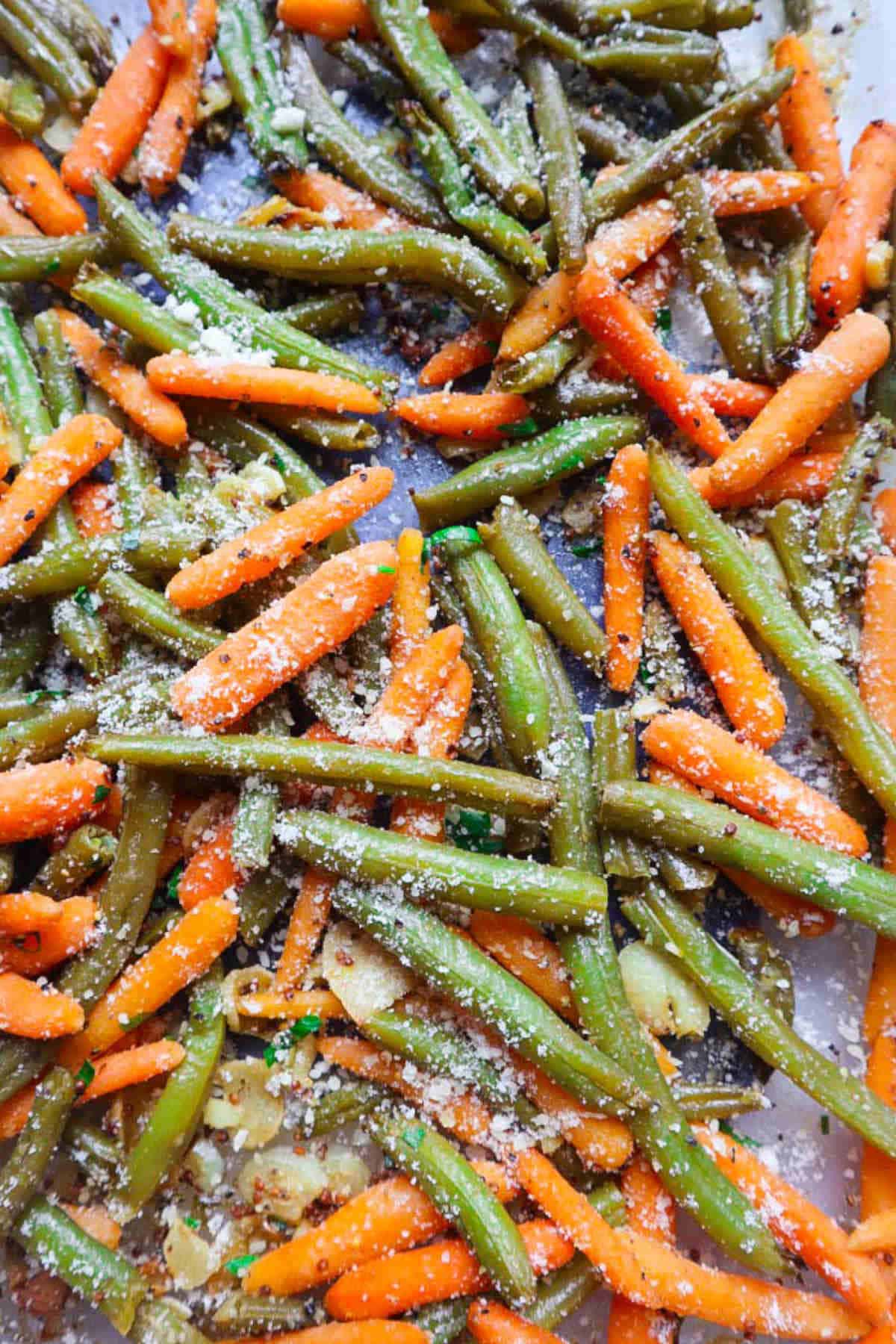 Close up image of roasted carrots and green beans.