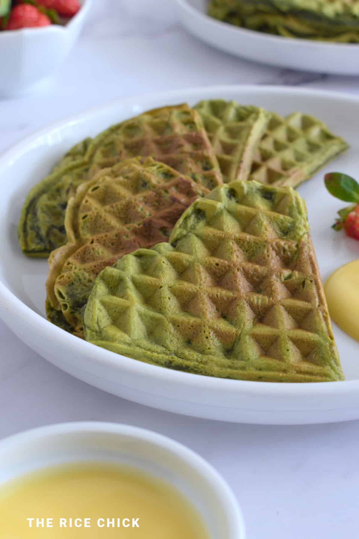 Close up image of matcha waffle pieces on a plate.
