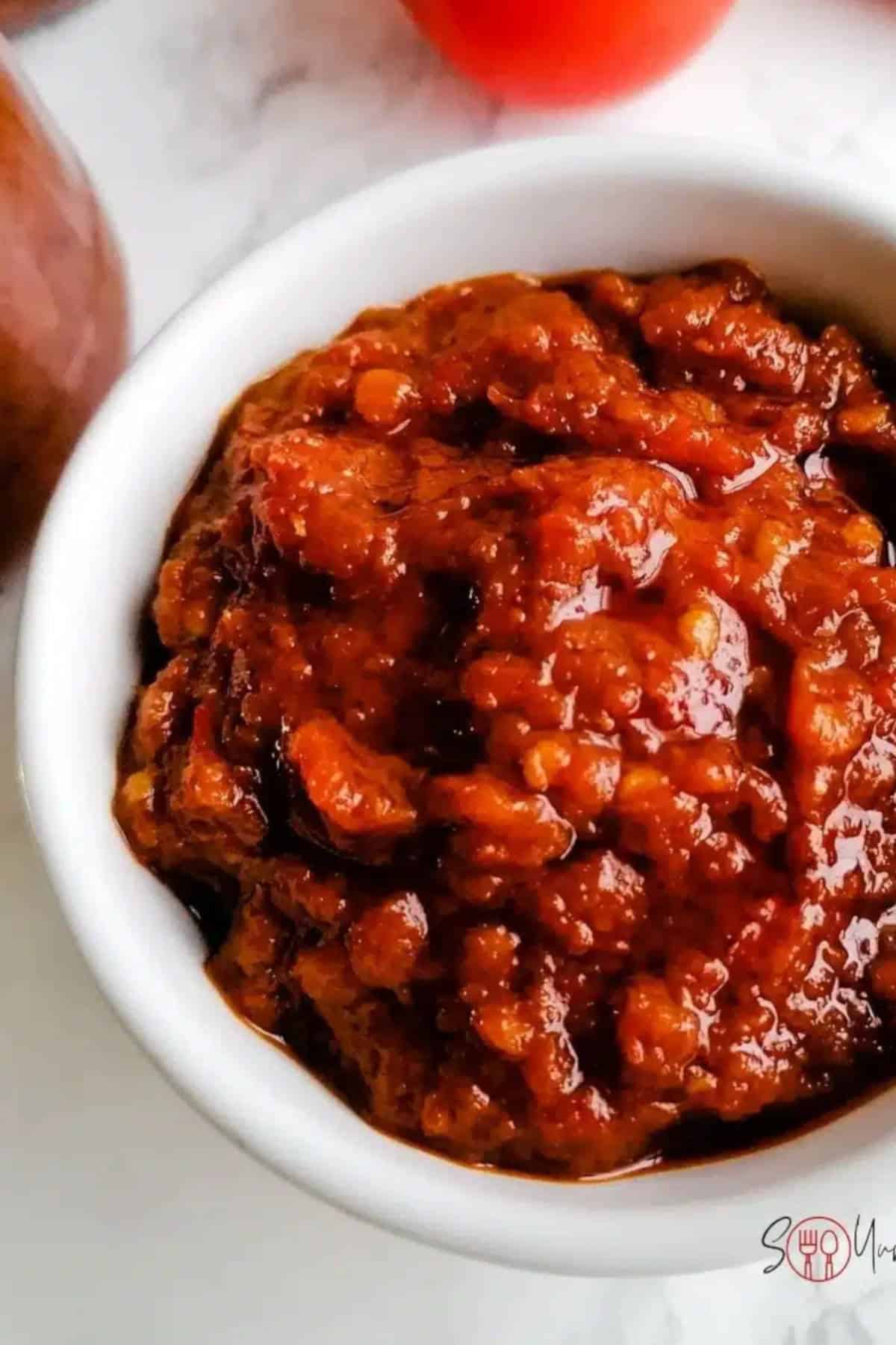 Close up image of sambal in a white bowl.