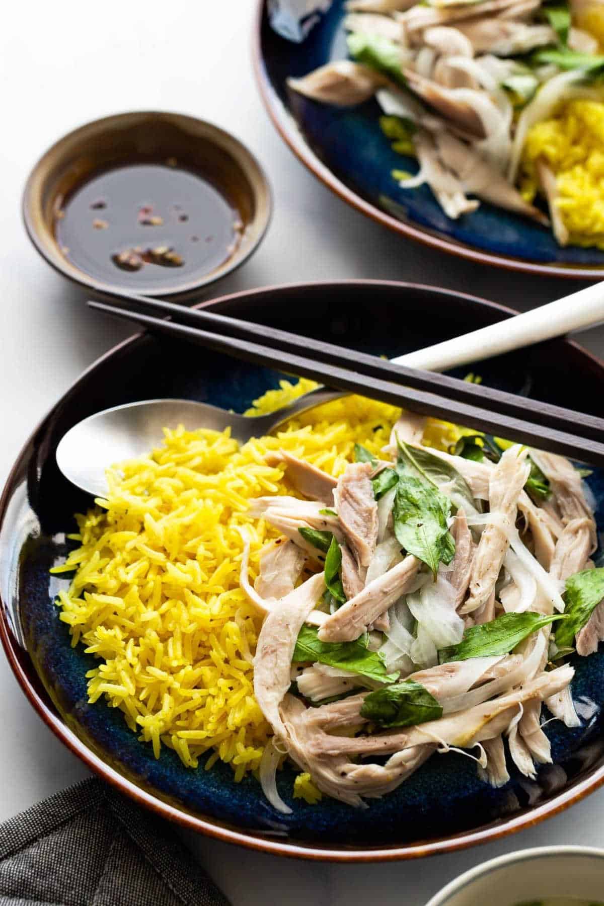 Vietnamese chicken rice on a black plate.