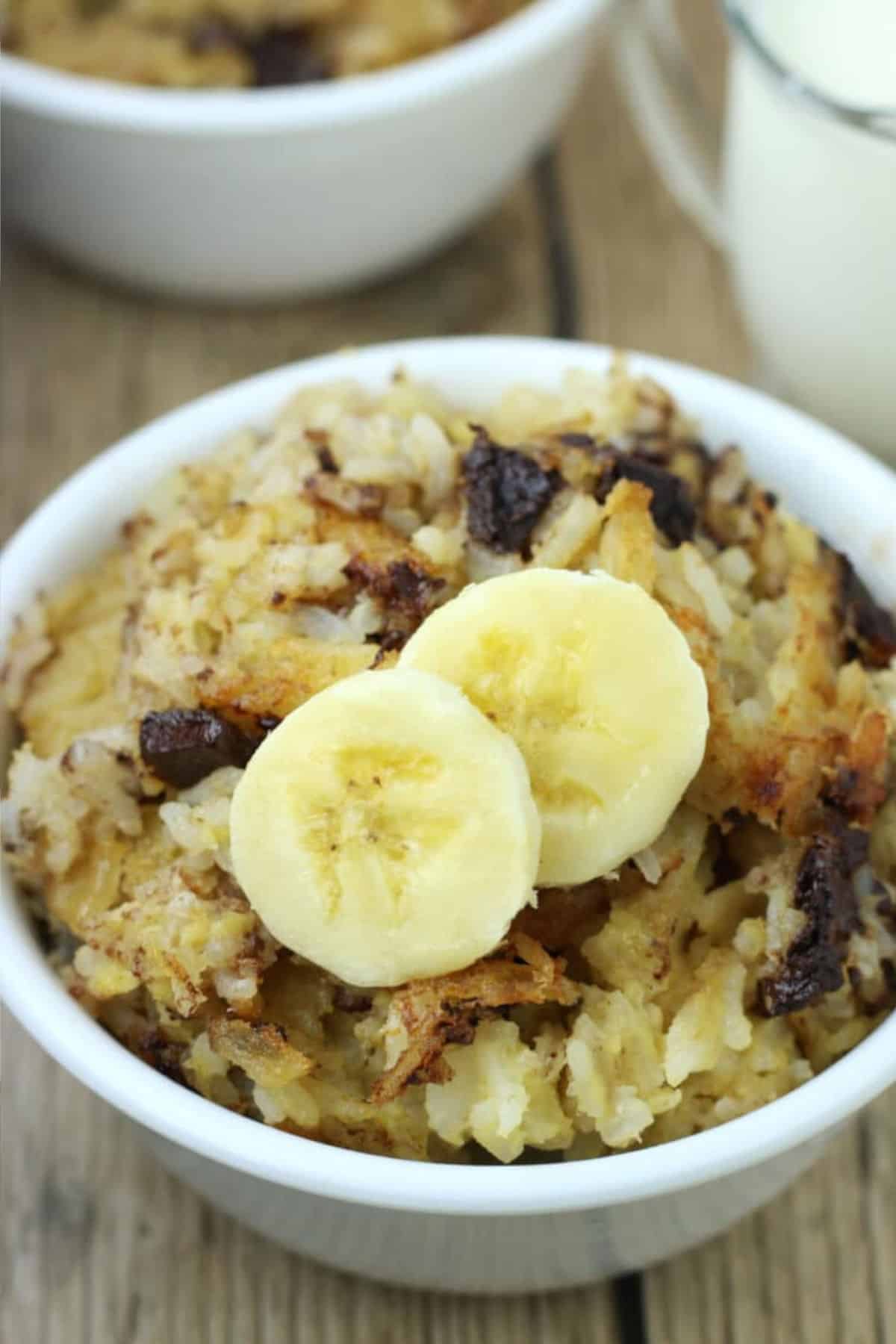 Close up image of rice pudding with banana slices.