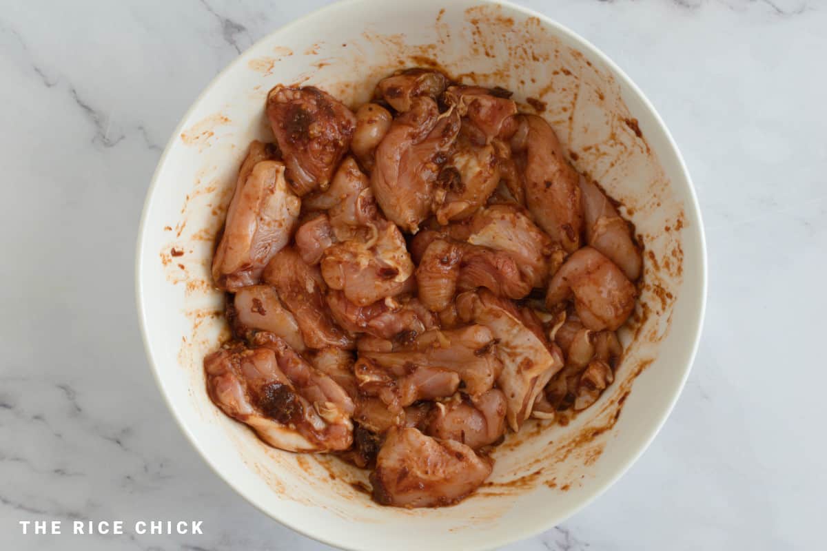 Marinating chicken in a bowl.