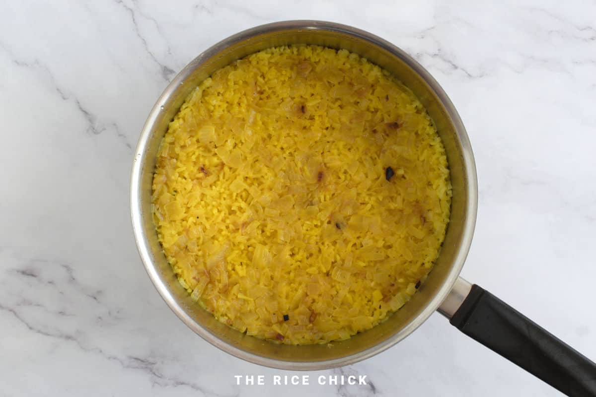 Cooked Mediterranean yellow rice in a saucepan.