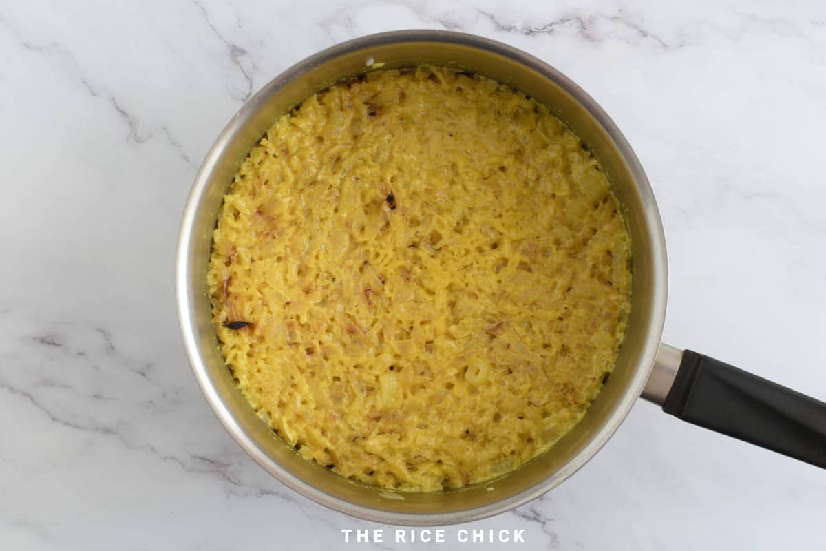 Cooked yellow rice in a saucepan.