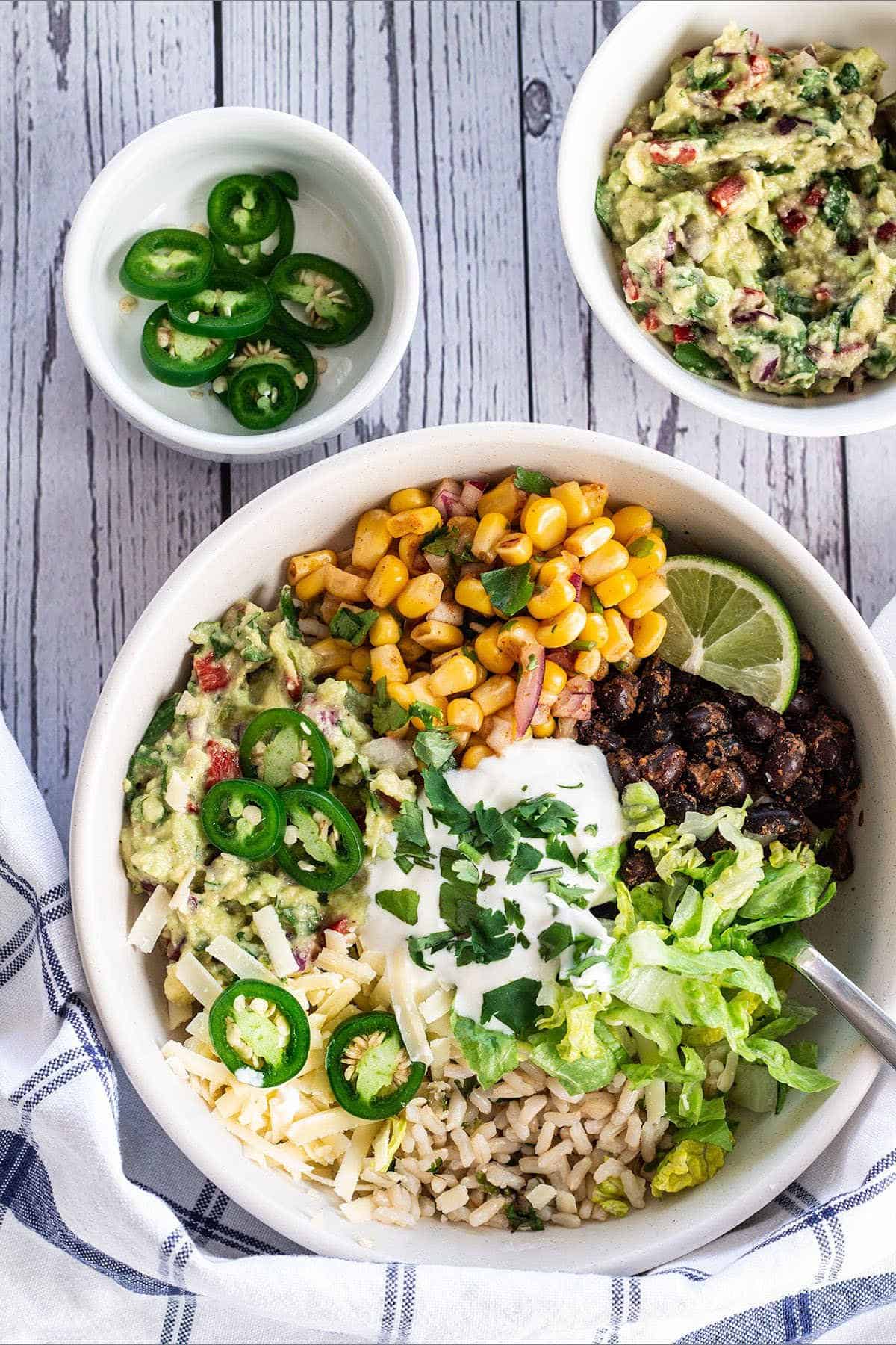 Vegetarian burrito bowl with a spoon.