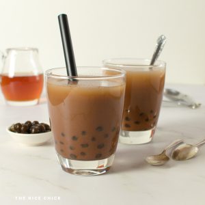 Chocolate bubble tea on a marble benchtop.