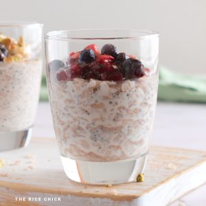 Close up of overnight rice flakes with berries in a glass.
