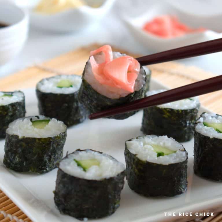 Sushi being held with chopsticks.