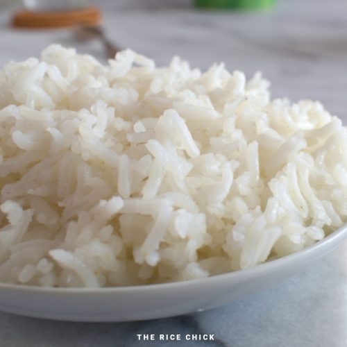 Close up image of cooked basmati rice in a white bowl.