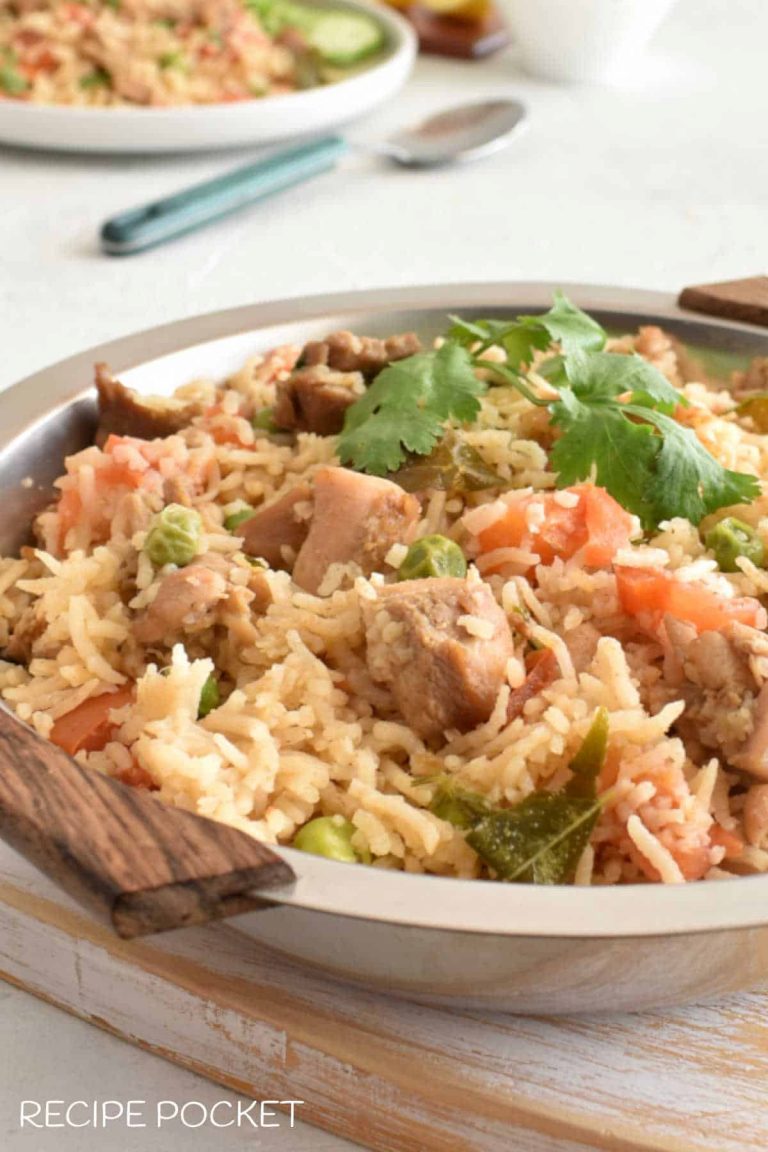 Chicken pulao in a round silver serving dish.