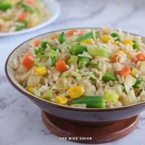 Close up image of fried rice in a brown bowl.