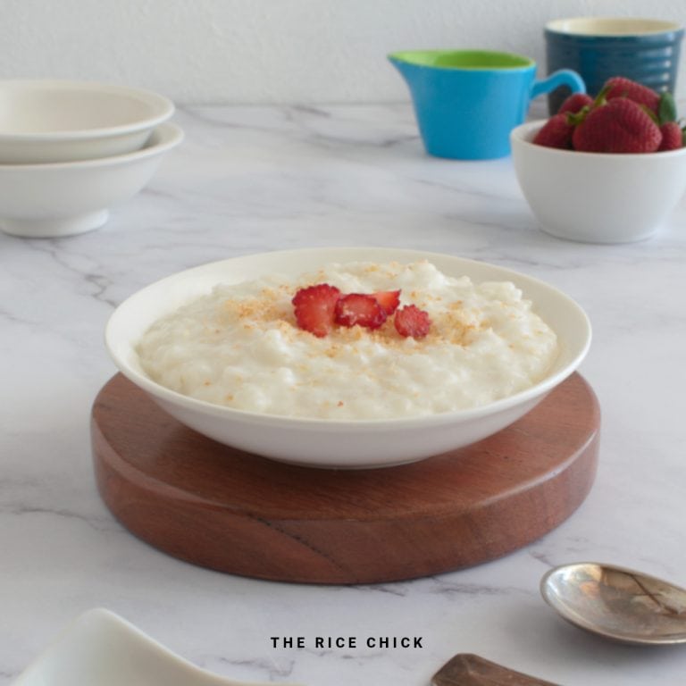 Close up image of rice pudding in a bowl with strawberries.