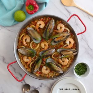 Close up image of seafood paella in a paella pan.