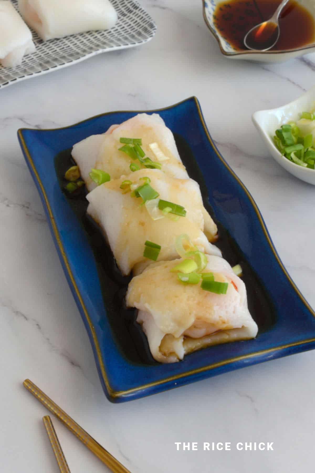 Steamed rice roll on a blue plate.